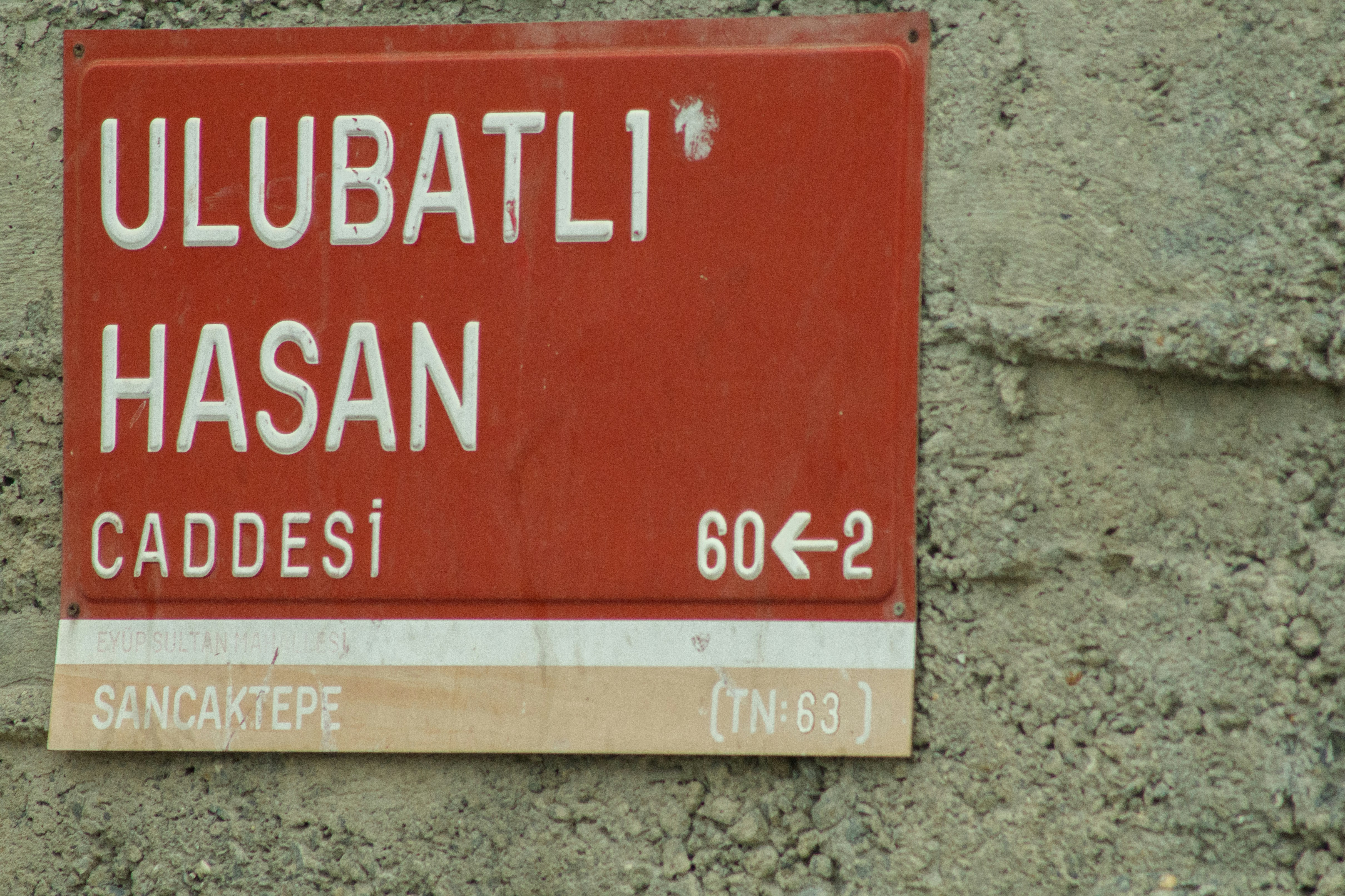 a red sign that is on the side of a building